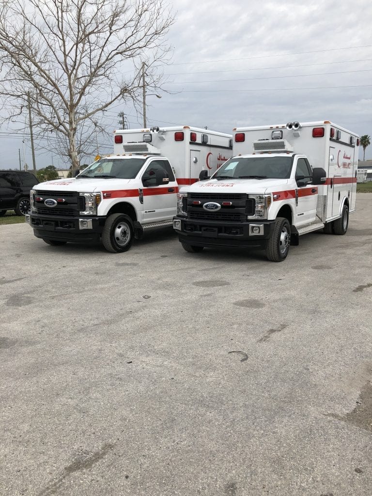 Two ambulances side by side - front angled view