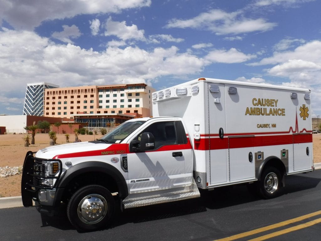 Causey ambulance in front of building - side view