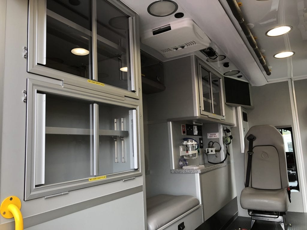 Inside of ambulance showing cabinets and ambulance seat