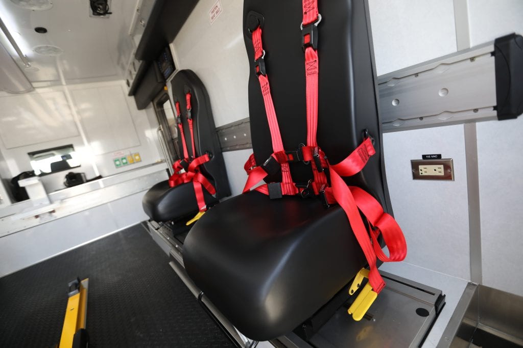 Inside of Lifeline ambulance showing ambulance seats and seatbelts