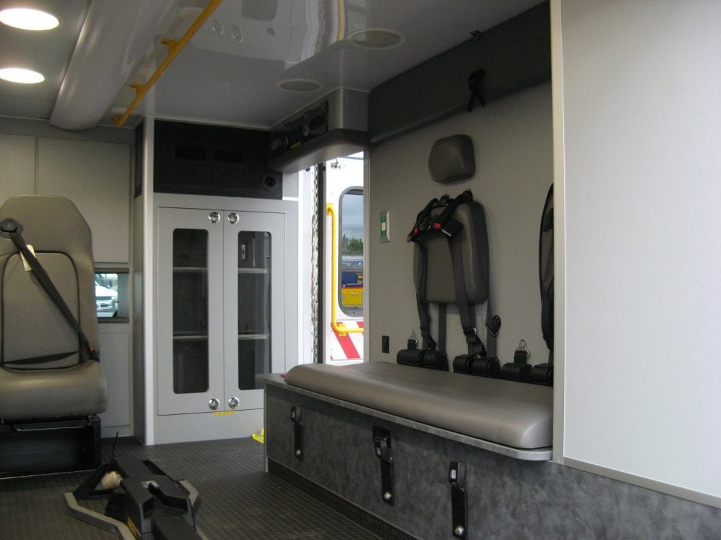 Iinside of ambulance showing cabinets and paramedic seat