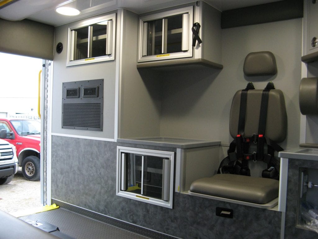 Iinside of ambulance showing cabinets and paramedic seat