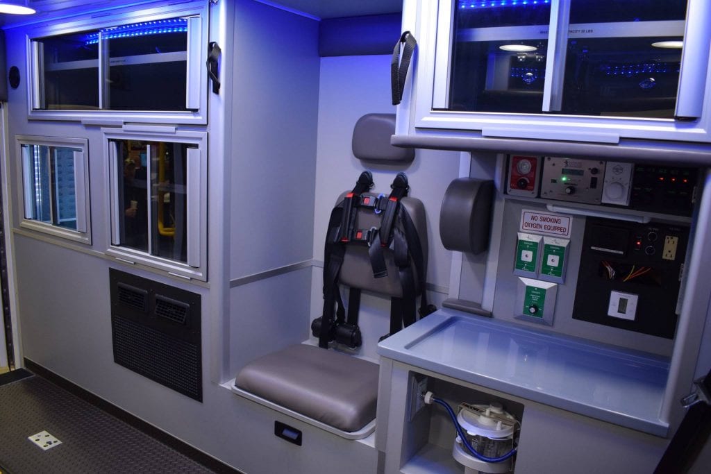 Inside view of ambulance - paramedic seat and cabinets