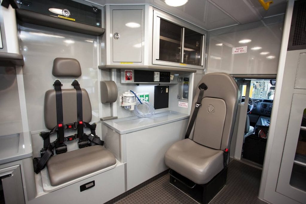 Inside of ambulance showing cabinets and seats
